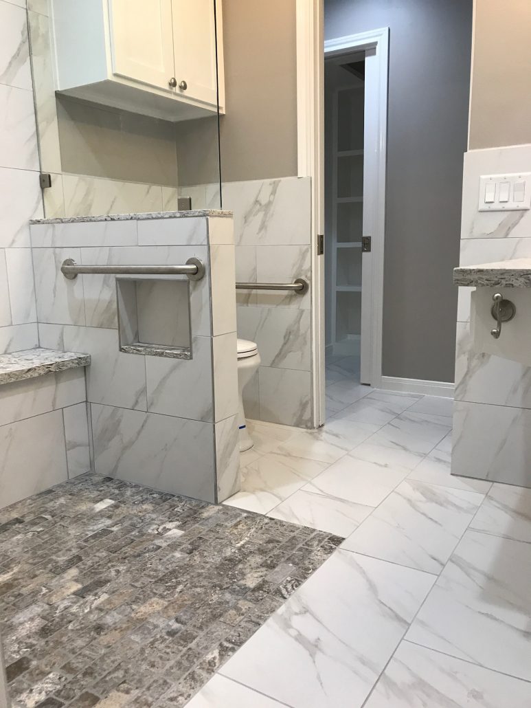 marble and stone ada compliant bathroom with shower seat and grab bars