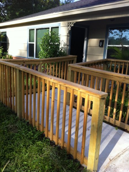 A residential Wheelchair Ramp made out of wood with square features