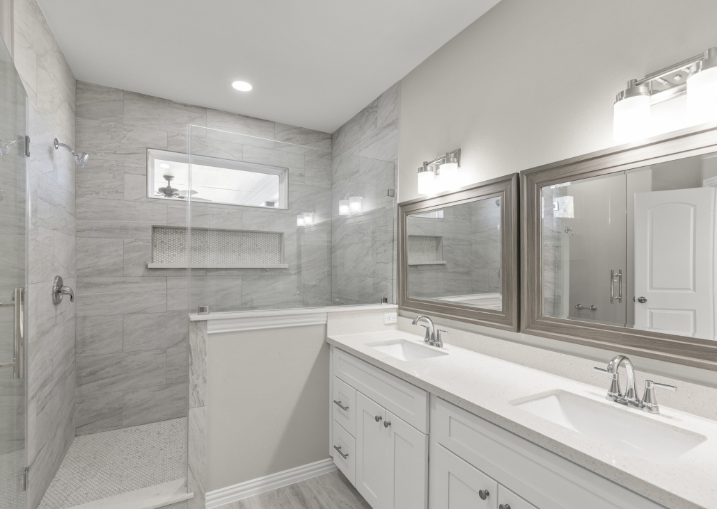 A modern bathroom remodel with light gray and white earth tones