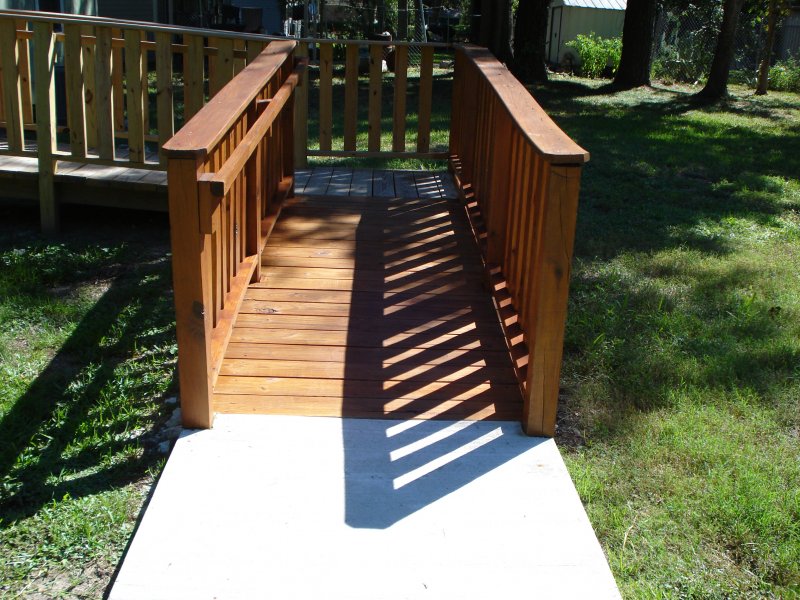 A residential Wheelchair Ramp made out of stained wood